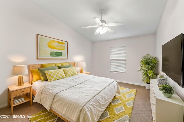 bedroom with ceiling fan, carpet floors, and vaulted ceiling