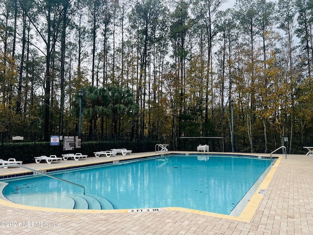 view of swimming pool with a patio area