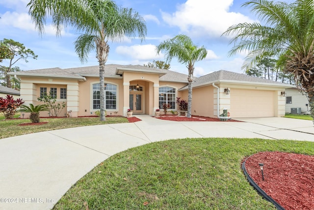 single story home with stucco siding, a front lawn, driveway, french doors, and a garage