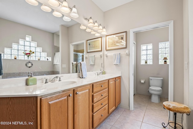 full bath with tile patterned floors, plenty of natural light, and a sink