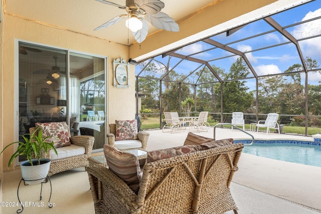 outdoor pool with a lanai, ceiling fan, and a patio area