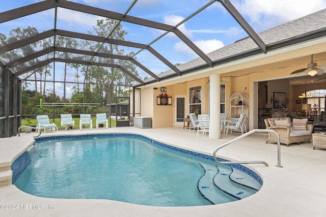 outdoor pool featuring a lanai, a ceiling fan, and a patio