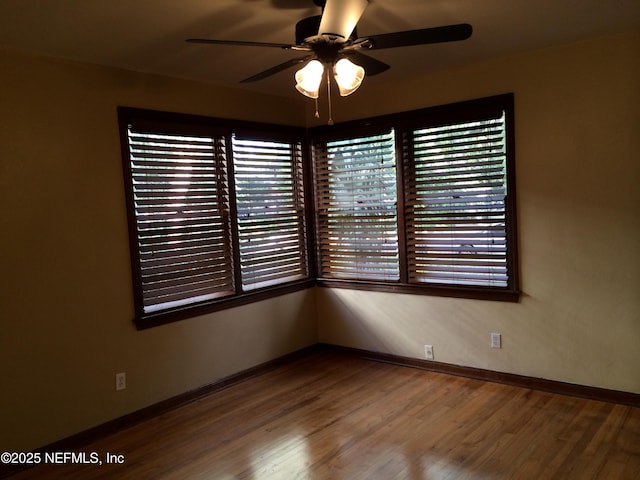 empty room featuring wood-type flooring and ceiling fan