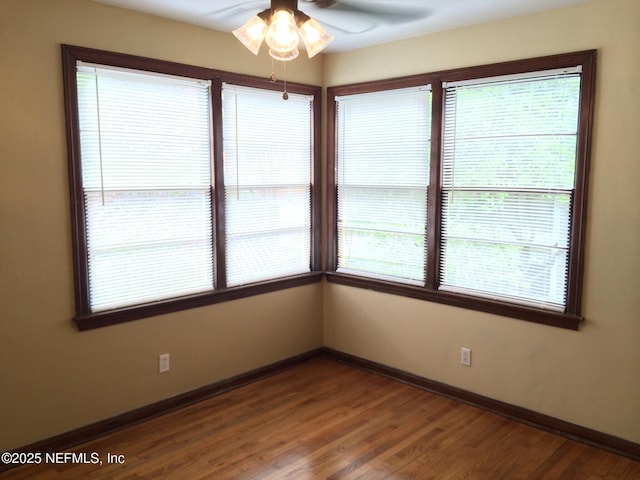 unfurnished room featuring hardwood / wood-style floors and ceiling fan