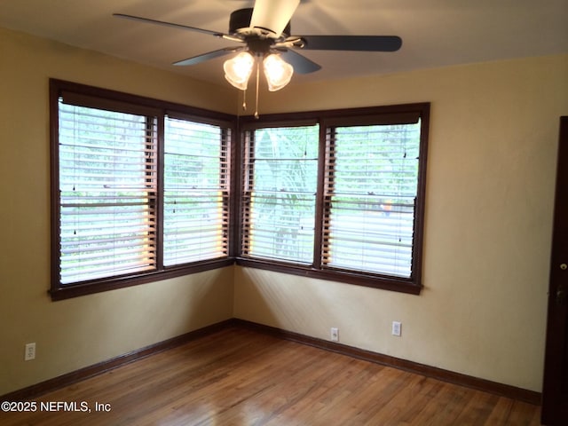 unfurnished room with wood-type flooring and ceiling fan