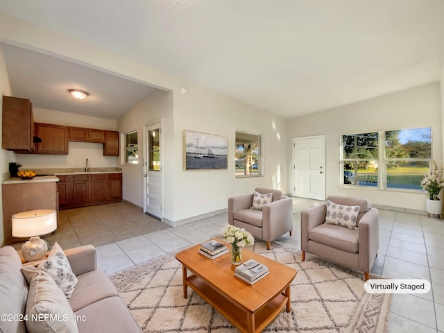 living room featuring sink, vaulted ceiling, and light tile patterned flooring