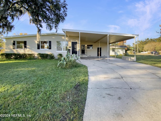 view of front facade with a front yard and a carport