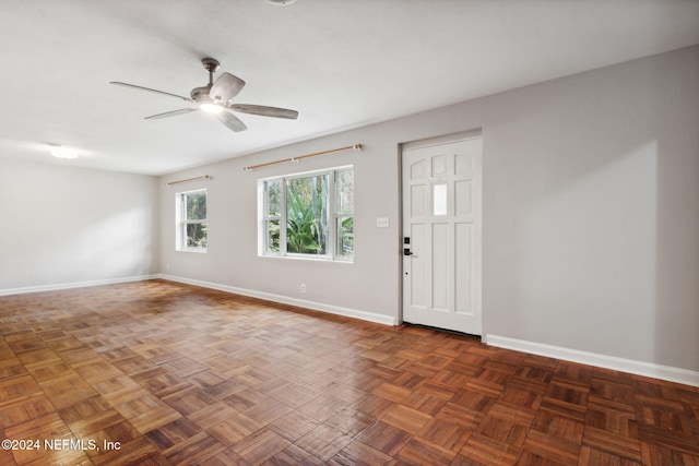 foyer featuring dark parquet floors and ceiling fan