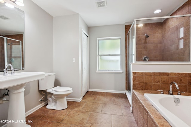 bathroom featuring tile patterned flooring, plus walk in shower, and toilet