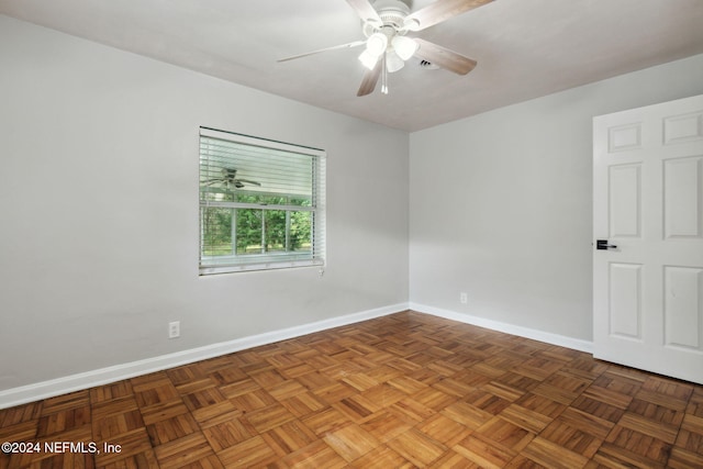 spare room featuring dark parquet flooring