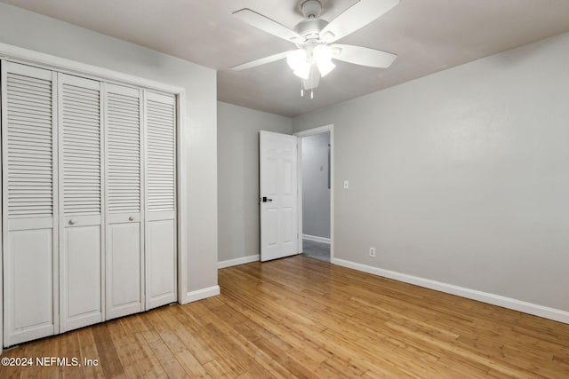 unfurnished bedroom featuring a closet, light hardwood / wood-style floors, and ceiling fan