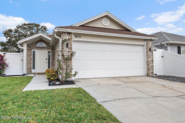 single story home with a garage and a front yard