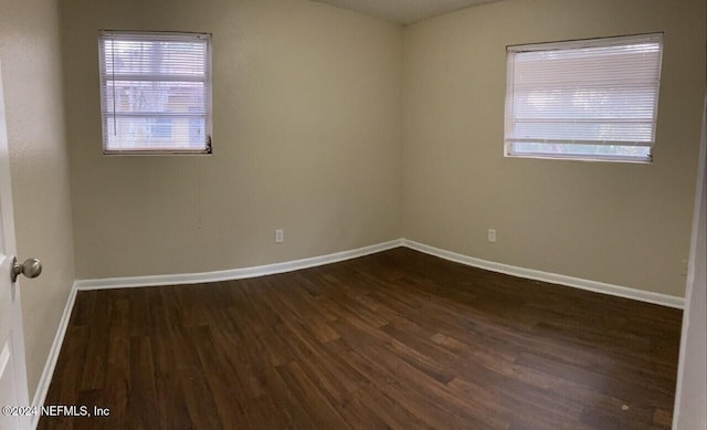 spare room featuring dark hardwood / wood-style flooring