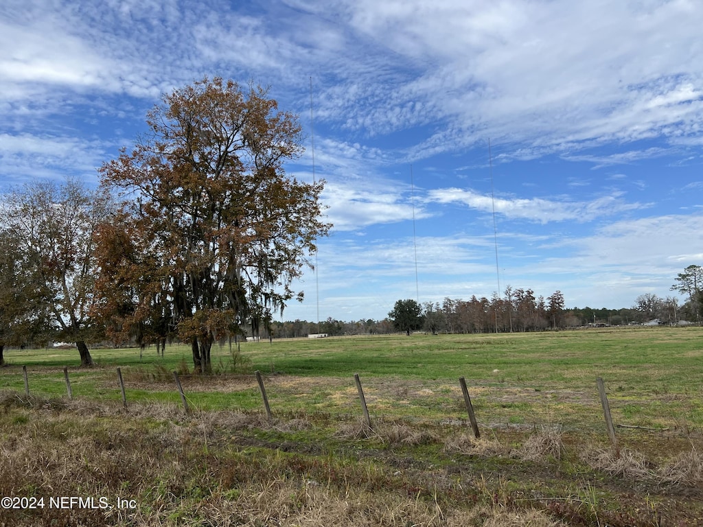 view of yard with a rural view