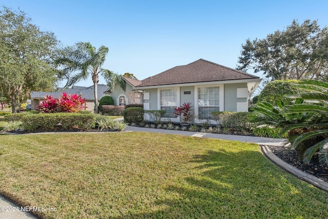 ranch-style home featuring a front lawn