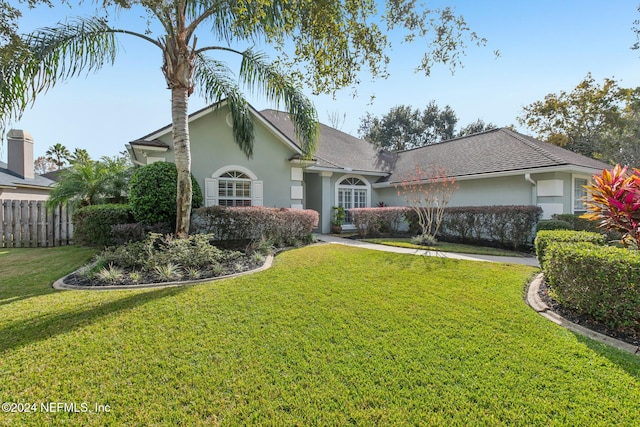 ranch-style home with a front lawn