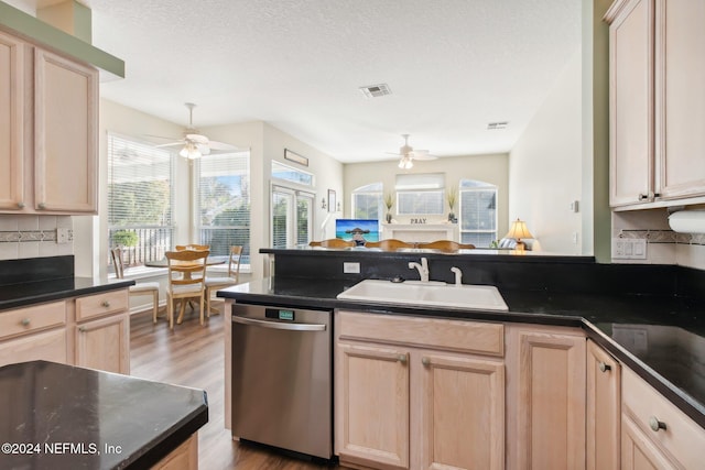 kitchen with dishwasher, hardwood / wood-style floors, light brown cabinets, and sink