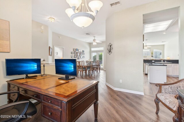 office space featuring ceiling fan and light hardwood / wood-style floors