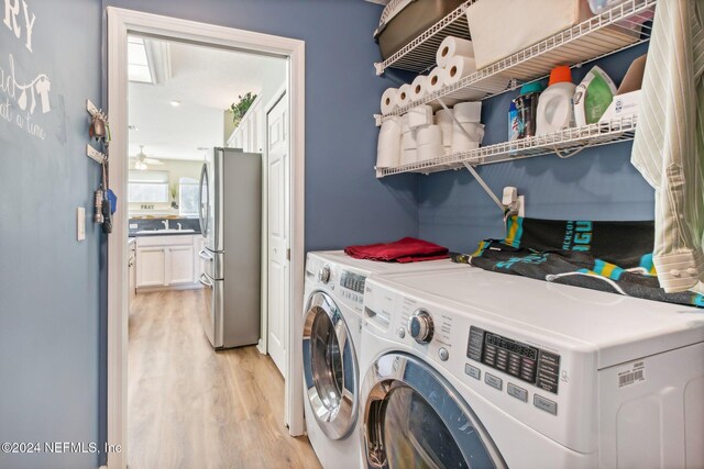 laundry room featuring light hardwood / wood-style floors and independent washer and dryer