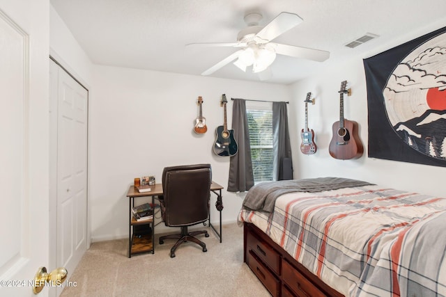 carpeted bedroom with a closet and ceiling fan