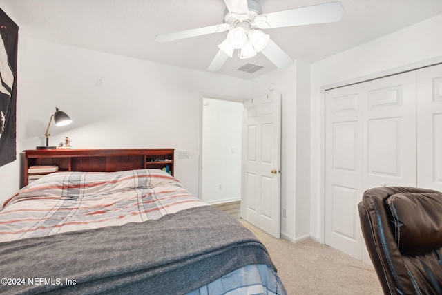 bedroom with carpet, ceiling fan, and a closet