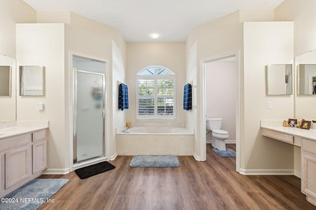 full bathroom featuring toilet, vanity, shower with separate bathtub, and hardwood / wood-style flooring