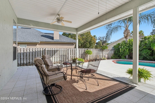 view of patio featuring a fenced in pool and ceiling fan