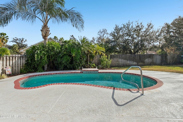 view of swimming pool with a patio area