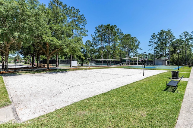 view of home's community with volleyball court and a yard