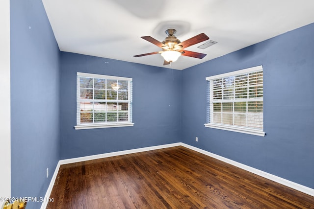 spare room featuring hardwood / wood-style floors, plenty of natural light, and ceiling fan