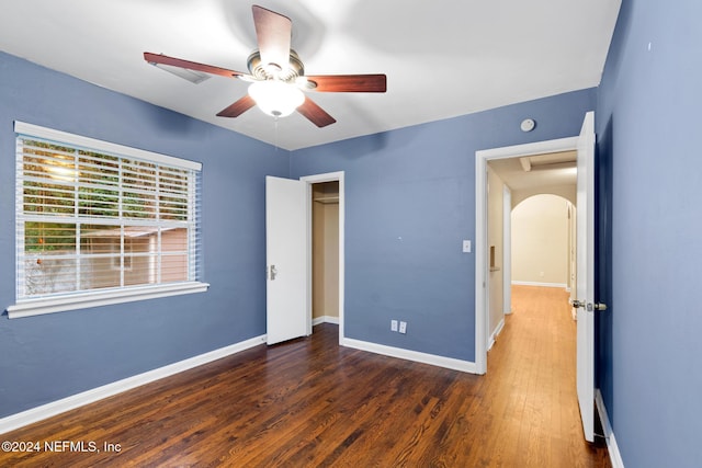 unfurnished bedroom featuring dark hardwood / wood-style floors and ceiling fan