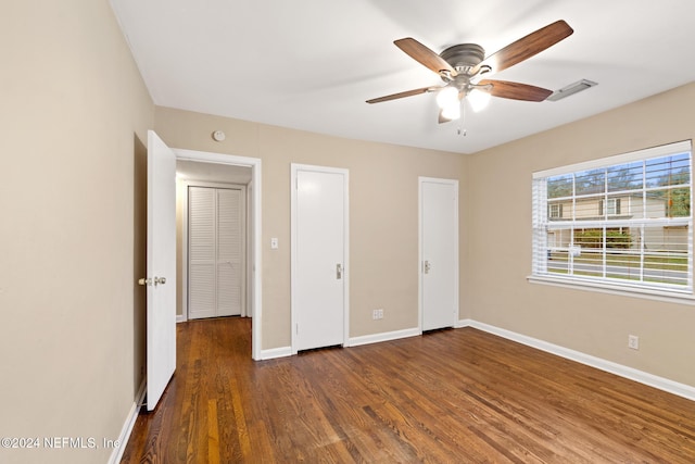 unfurnished bedroom featuring ceiling fan and dark hardwood / wood-style floors