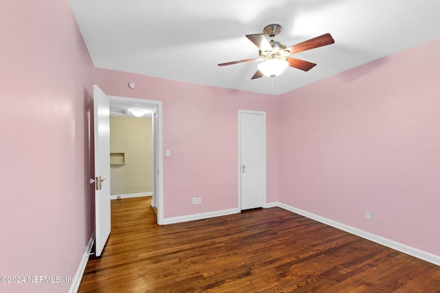 unfurnished bedroom featuring ceiling fan and dark hardwood / wood-style flooring