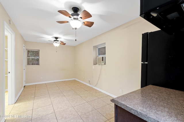 tiled empty room with ceiling fan and cooling unit