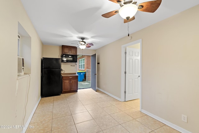 kitchen featuring light tile patterned flooring and black appliances