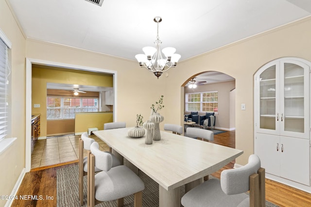 dining room featuring a wealth of natural light, dark hardwood / wood-style floors, and ornamental molding