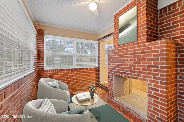 sunroom / solarium with ceiling fan, a wealth of natural light, and wood ceiling