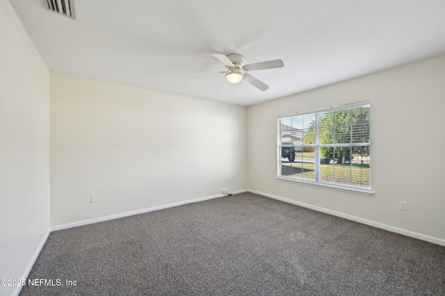 carpeted spare room featuring ceiling fan