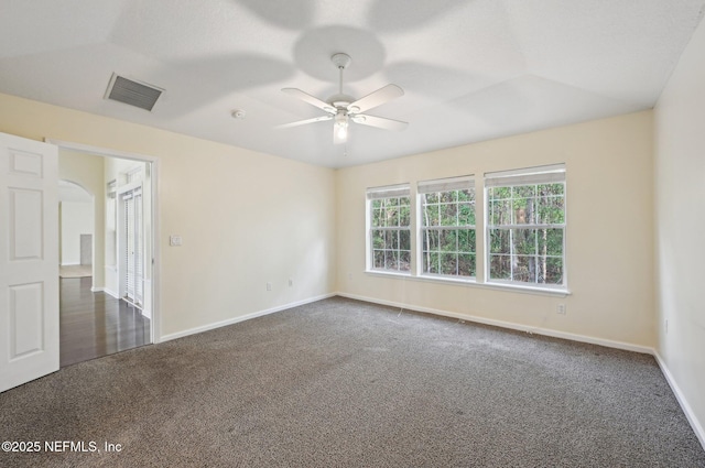 unfurnished room featuring ceiling fan and dark carpet