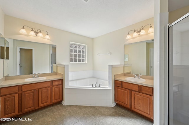 bathroom with shower with separate bathtub, vanity, and tile patterned floors