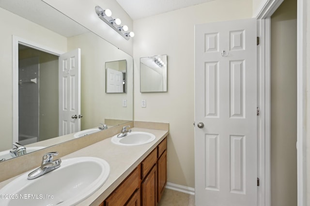 bathroom with tile patterned flooring and vanity