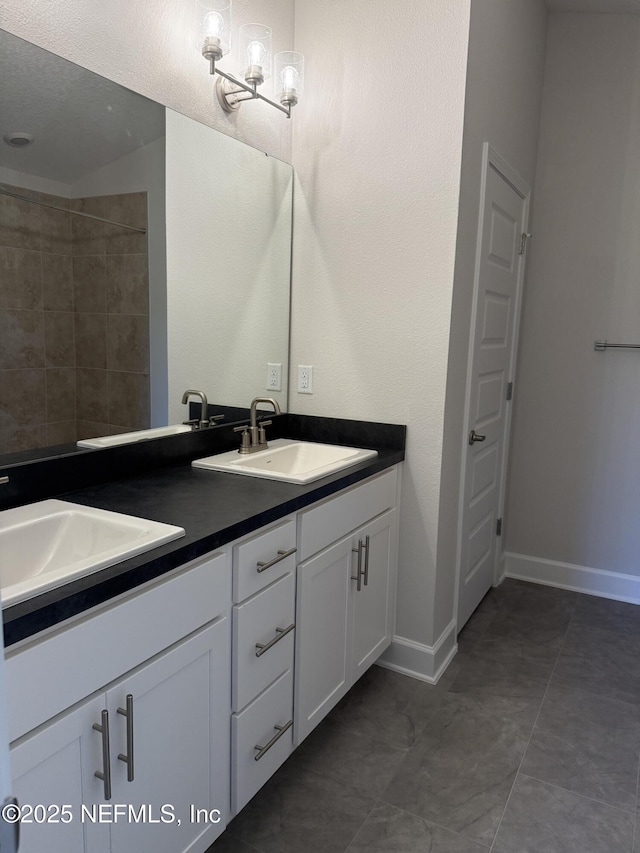 8195 Elsdon St, Jacksonville, FL 32219 - bathroom featuring double vanity, baseboards, and a sink