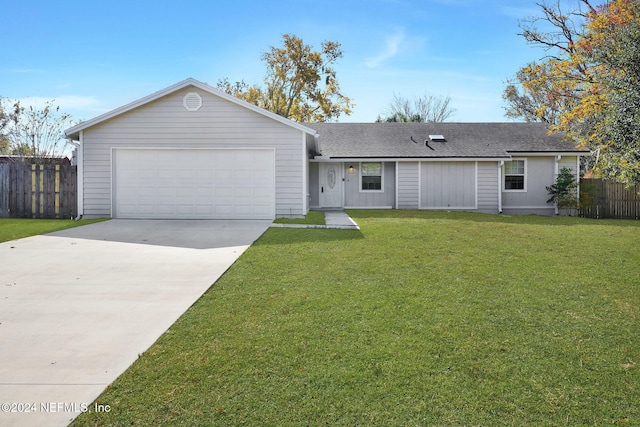 ranch-style house with a front yard and a garage