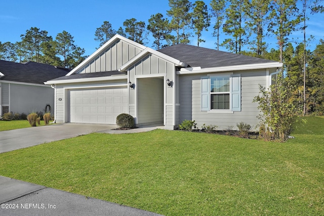 view of front of home featuring a front yard and a garage