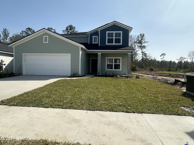 traditional-style house featuring a garage, driveway, and a front lawn