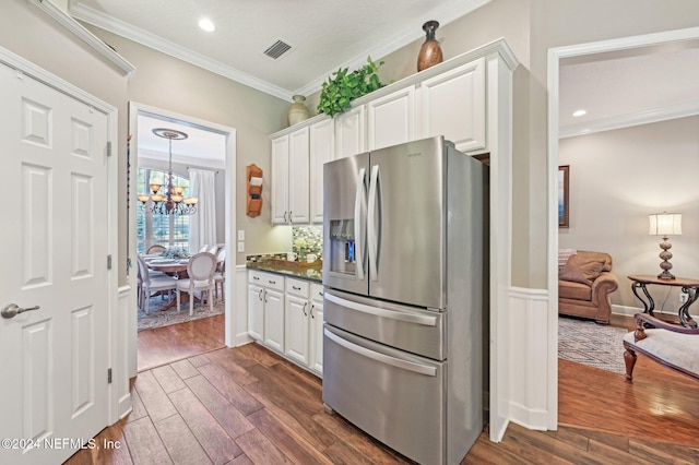 kitchen featuring white cabinets, stainless steel fridge, and dark hardwood / wood-style floors