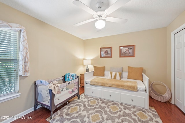 bedroom featuring ceiling fan and dark wood-type flooring