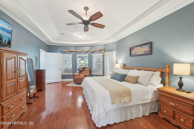 bedroom with hardwood / wood-style floors, a raised ceiling, ceiling fan, and crown molding