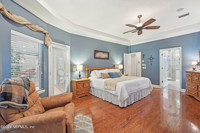 bedroom with ensuite bath, ceiling fan, crown molding, and hardwood / wood-style flooring