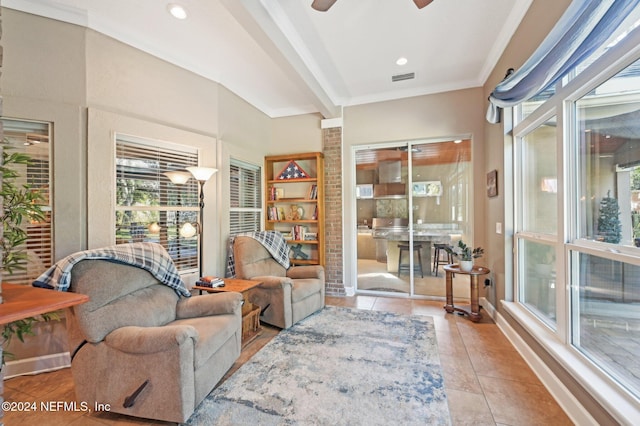 living area with light tile patterned floors and ceiling fan